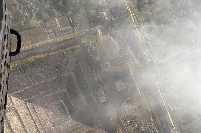 Aerial view looking down through morning haze at fields and roads in the valley